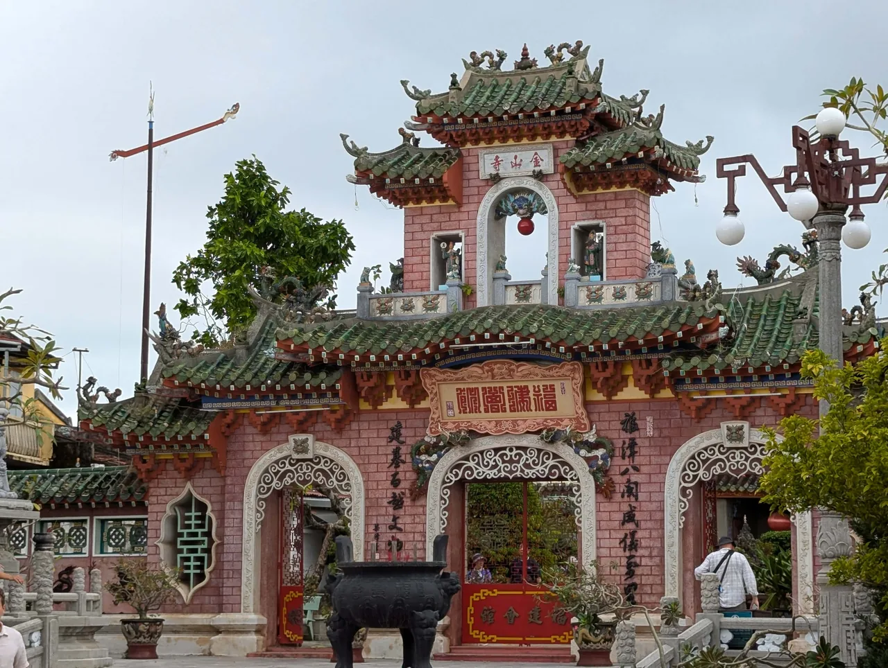Ornate gateway with green tiled roofs at the Fujian Assembly Hall in Hoi An, Vietnam